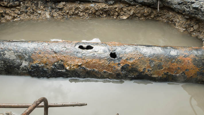 Corroded pipe leaking under a slab in a San Diego home